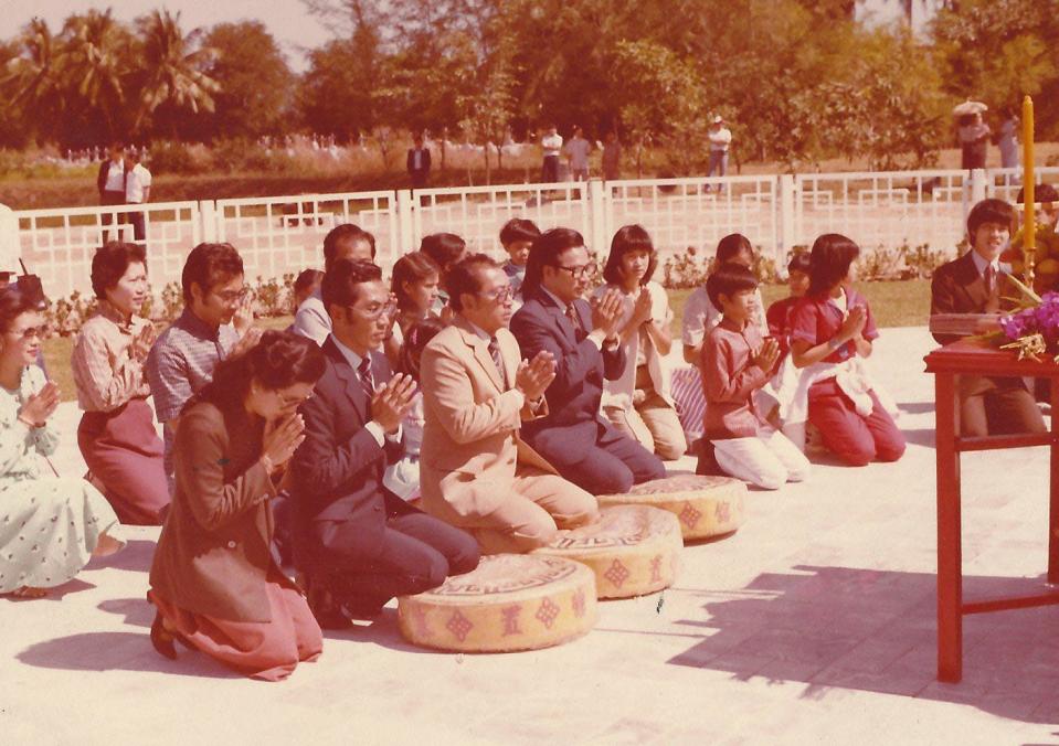 The Sosothikul family seen here in this photograph offering blessings at Boonsom's and Veheai's graves.