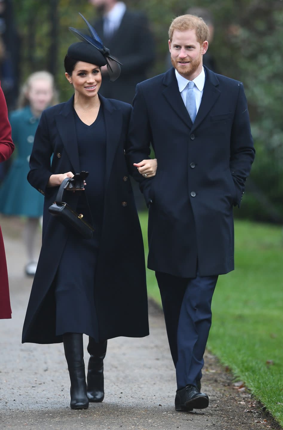 Prince Harry and Meghan Markle arrive arm-in-arm for the royal family's Christmas Day church service.