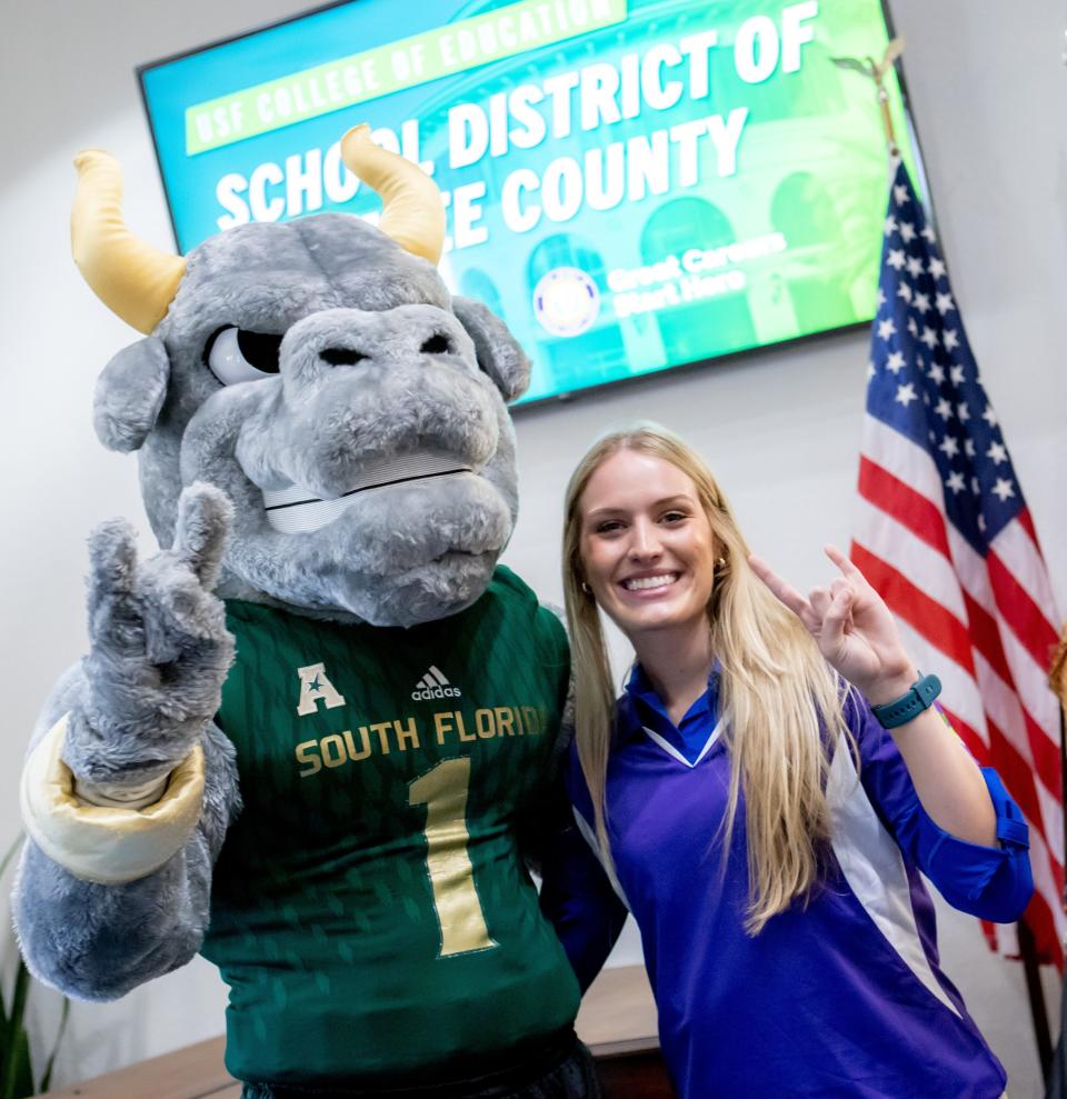 USF mascot Rocky D. Bull joins the fanfare on Education Signing Day with Anna Bunyak, who is headed to McNeal Elementary School in Lakewood Ranch.