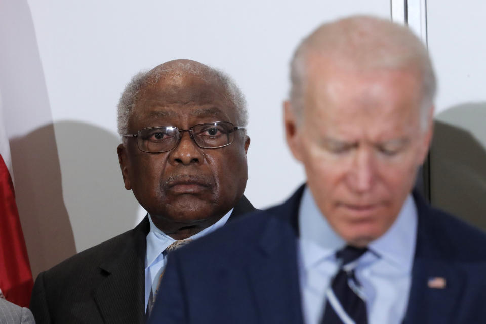 FILE - In this Feb. 26, 2020 file photo, House Majority Whip, Rep. Jim Clyburn, D-S.C., background, listens as Democratic presidential candidate former Vice President Joe Biden, speaks at an event where Clyburn endorsed him in North Charleston, S.C. Political endorsements aren’t generally thought of as carrying much heft, used by candidates and endorsers alike for a momentary media bounce, then becoming names added to a growing list. But Clyburn’s backing of Biden could be the endorsement that not only boosted voters to give the former vice president his first-ever primary win in South Carolina but also helped pave the way to his presidential nomination by way of a consolidation of moderate Democrats who, one by one, have since shuttered their campaigns to support him. (AP Photo/Gerald Herbert, File)