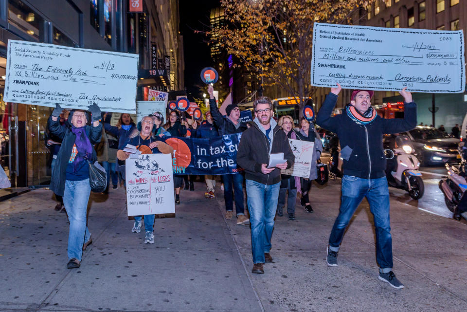 <p>Over a hundred protesters met at Greeley Square in Midtown Manhattan on Nov. 27, 2017 and marched along 34th Street behind a “Not One Penny of Tax Cuts for the Rich” banner, with “Tax Scam” signs, “Not One Penny” signs and giant checks made out from Medicaid or Medicare to billionaires or corporations, to raise awareness against the irresponsible tax plan that cuts Medicare and increases healthcare costs for older New Yorkers. (Photo: Erik Mcgregor/Pacific Press via ZUMA Wire) </p>