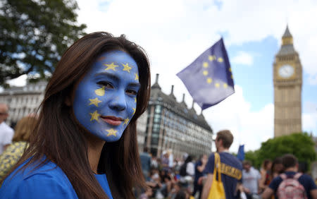 A woman with a painted face poses for a photograph during a 'March for Europe' demonstration against Britain's decision to leave the European Union, in central London, Britain July 2, 2016. Britain voted to leave the European Union in the EU Brexit referendum. REUTERS/Neil Hall