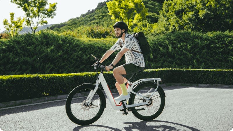 A photo of a man riding an NIU E Bike. 