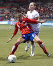 VANCOUVER, CANADA - JANUARY 27: Carol Sanchez #6 of Costa Rica shields the ball from Lauren Cheney #12 of the United States during the first half of semifinals action of the 2012 CONCACAF WomenÕs Olympic Qualifying Tournament at BC Place on January 27, 2012 in Vancouver, British Columbia, Canada. (Photo by Rich Lam/Getty Images)