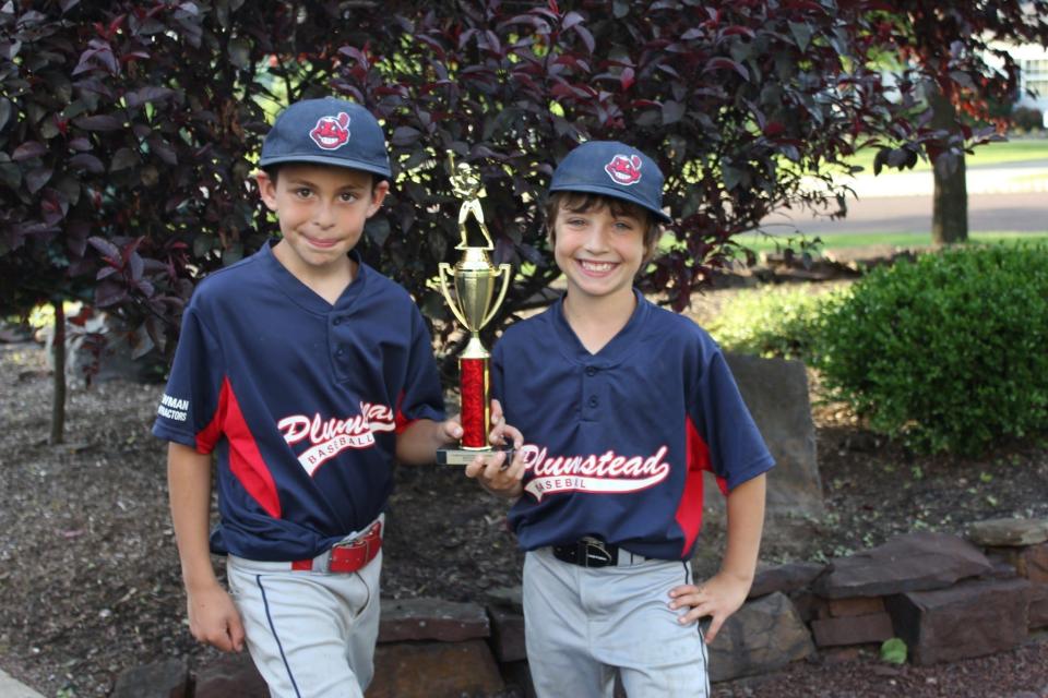 Nine-year-old Max McGlone, left, and Julio Ermigiotti display their Plumstead Baseball Association championship trophy.