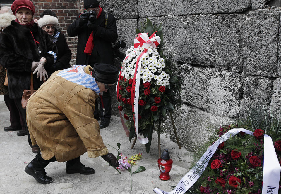 Auschwitz survivors lay a wreath and flowers at the former Nazi death camp's Executions wall in Oswiecim, Poland, on Monday, Jan. 27, 2014, to mark 69 years since the Soviet Red Army liberated the camp. Israeli lawmakers and government officials are to attend anniversary observances later in the day. The Nazis killed some 1.5 million people, mostly Jews at the camp during World War II.(AP Photo/Czarek Sokolowski)