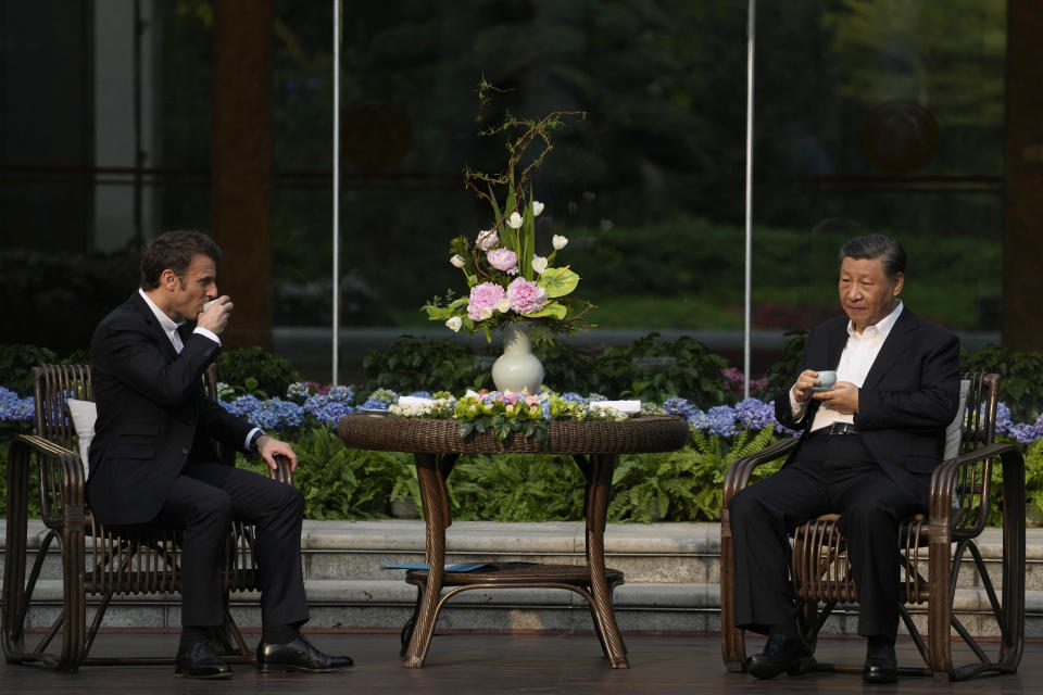 Chinese President Xi Jinping, right, and France's President Emmanuel Macron attend a tea ceremony at the Guandong province governor's residence in Guangzhou, China, Friday, April 7, 2023. (AP Photo/Thibault Camus, Pool)