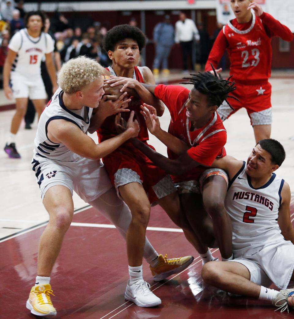 Tulare Western's Michael Johnson grabs the rebound but is tied up in the final seconds against North during their 72nd annual Polly Wilhelmsen Invitational Basketball Tournament championship game in Visalia, Calif., Saturday, Dec. 30, 2023.