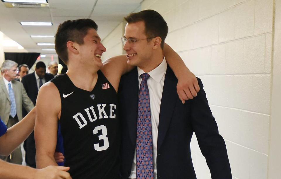 Duke guard Grayson Allen (3) hugs assistant coach Jon Scheyer as they head to the locker room as Duke upset UNC 74-74 at the Smith Center in Chapel Hill, N.C. Wednesday, February 17, 2016.