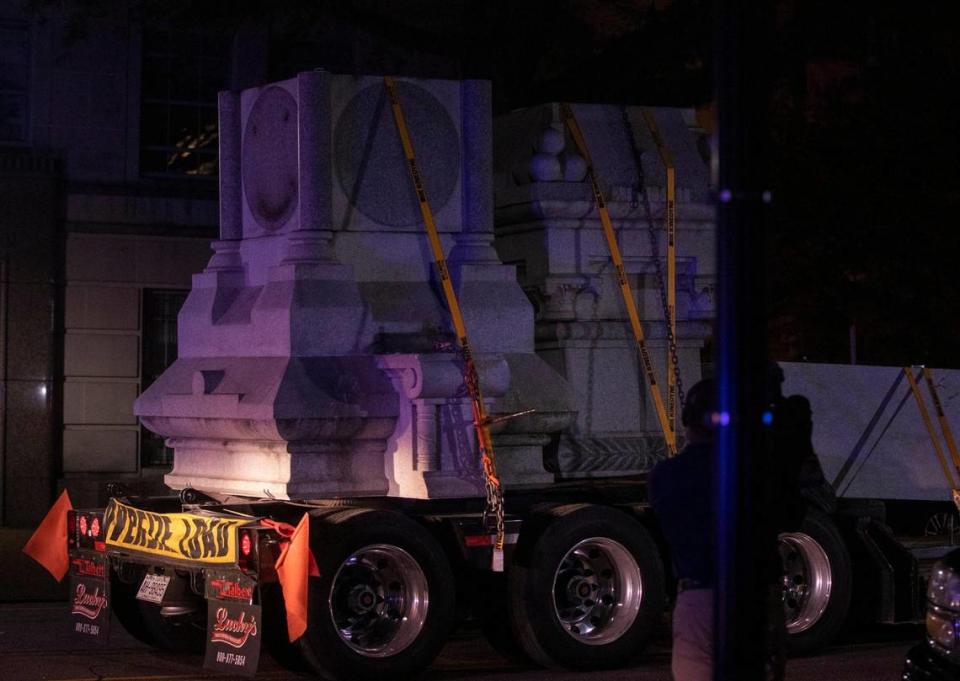 The top three granite sections of the 75-foot Confederate monument on the North Carolina Capitol grounds leave on a trailer in the process to complete its removal after it stood for 125 years honoring the “bravery of the Southern soldier” in the Civil War, on Wednesday night, Jun. 23, 2020, in Raleigh, N.C. Gov. Roy Cooper ordered its removal, along with two other Confederate monuments, the day after protesters pulled down two bronze soldiers that stood midway on the monumentÕs base and law enforcement officers were injured.