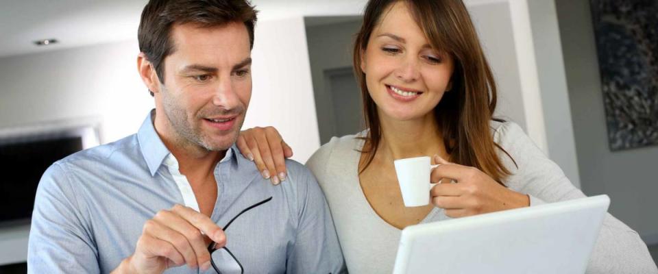 Couple at home looking at future home blueprint