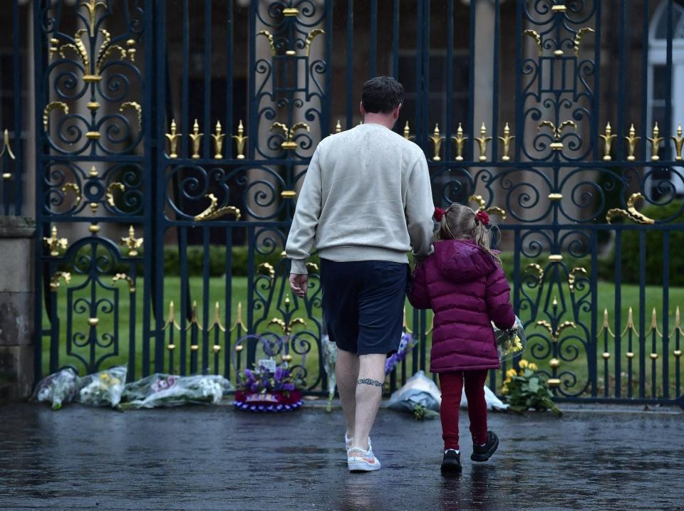 Mourners lay flowers at Hillsborough castle in Ireland following Wueen Elizabeth's death.