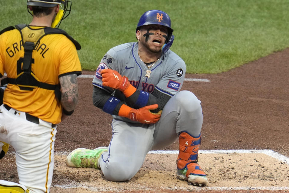 New York Mets' Francisco Alvarez, right, reacts after being hit on the elbow by a pitch from Pittsburgh Pirates starter Paul Skenes during the fourth inning of a baseball game in Pittsburgh, Friday, July 5, 2024. (AP Photo/Gene J. Puskar)