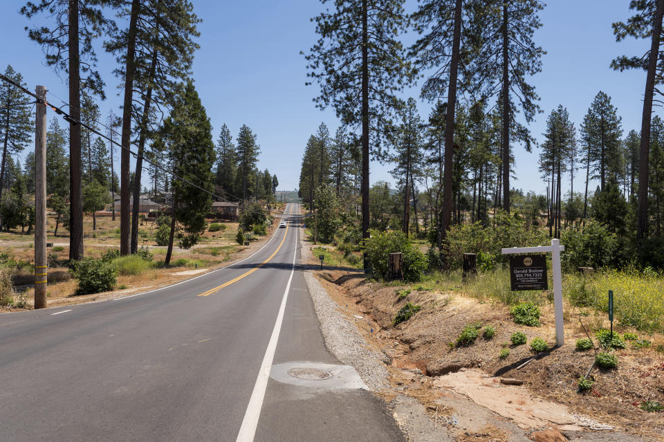 A car drives down Wagstaff Road in Paradise, Calif., Friday, June 14, 2024. Paradise is now the fastest growing city in California. (AP Photo/Nic Coury)