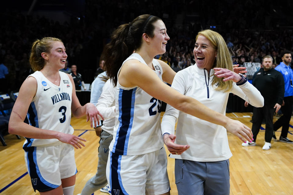 Villanova's Lucy Olsen (3), Maddy Siegrist (20) and head coach Denise Dillon celebrate after winning a second-round college basketball game against Florida Gulf Coast in the NCAA Tournament, Monday, March 20, 2023, in Villanova, Pa. (AP Photo/Matt Rourke)