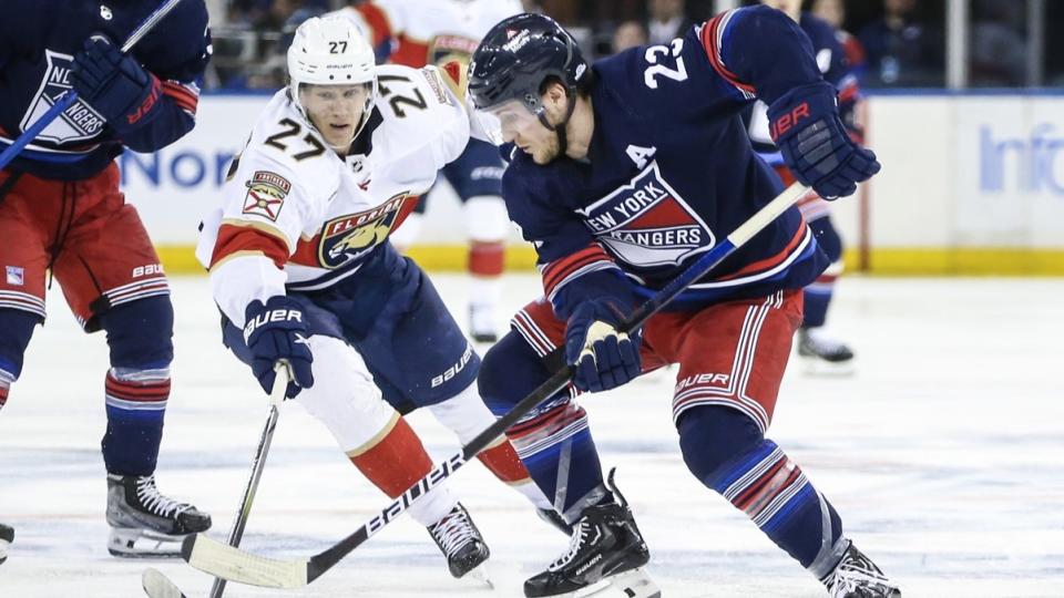 March 23, 2024;  New York, New York, USA;  Florida Panthers center Eetu Luostarinen (27) and New York Rangers defenseman Adam Fox (23) battle for control of the puck in the third period at Madison Square Garden. 