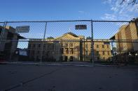 Two layers of security fencing is shown encircling the Arizona Capitol Saturday, Jan. 16, 2021, in Phoenix. With the FBI warning of potential violence at all state capitols Sunday, Jan. 17, the ornate halls of government and symbols of democracy looked more like heavily guarded U.S. embassies in war-torn countries. (AP Photo/Ross D. Franklin)