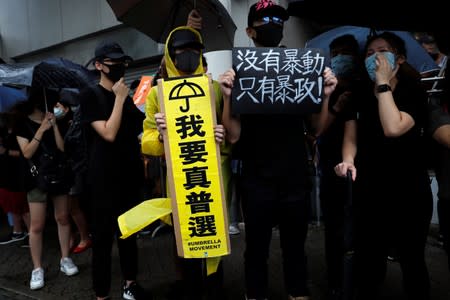 Supporters gather outside the Eastern Courts to support the arrested anti-extradition bill protesters who face rioting charges, in Hong Kong