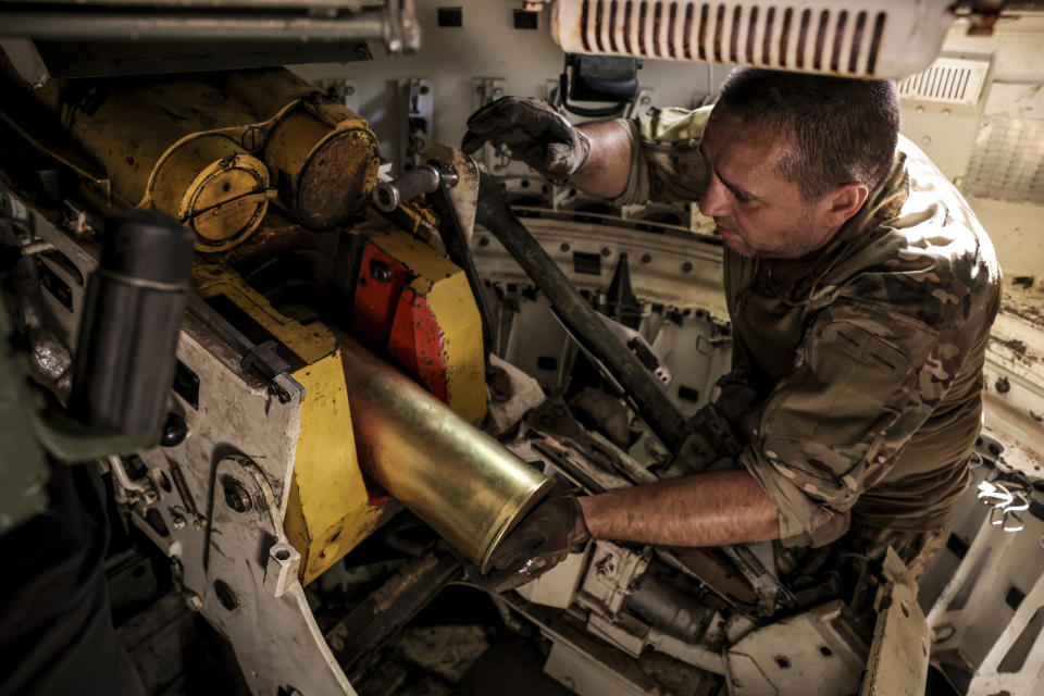 In this photo provided by Ukraine's 24th Mechanised Brigade press service, a serviceman prepares to fire a "Gvozdika" 120mm Soviet-made howitzer towards Russian positions at outskirts of Chasiv Yar, Donetsk region, Ukraine, Saturday, June 22, 2024. (Oleg Petrasiuk/Ukraine's 24th Mechanised Brigade via AP)