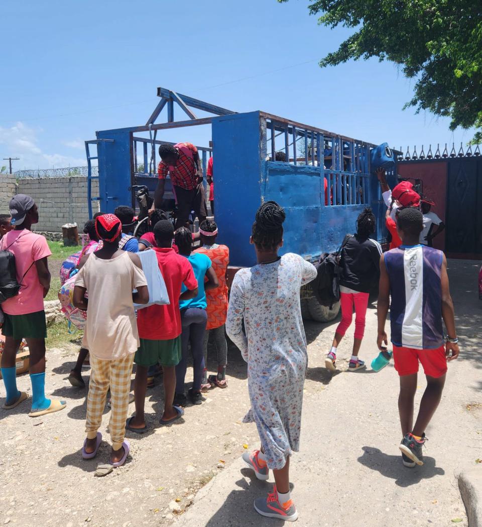 Residents of the Black and White for Jesus Ministries orphanage in Haiti load onto a truck as they prepare to evacuate the compound in early August. David Wine, a Polk County native, has operated the orphanage for about a decade.