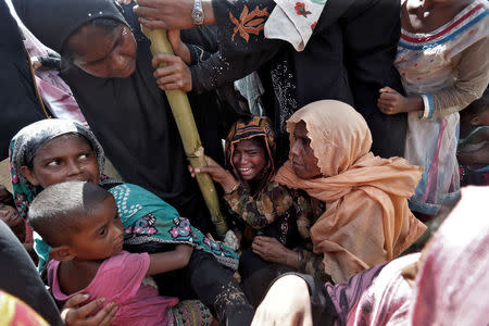 Rohingya refugees wait to receive aid in Cox's Bazar, Bangladesh, September 25, 2017. REUTERS/Cathal McNaughton