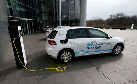 FILE PHOTO: AN e-Golf electric car is pictured charging outside the new production line of the Transparent Factory of German carmaker Volkswagen in Dresden, Germany March 30, 2017. REUTERS/Fabrizio Bensch/File Photo