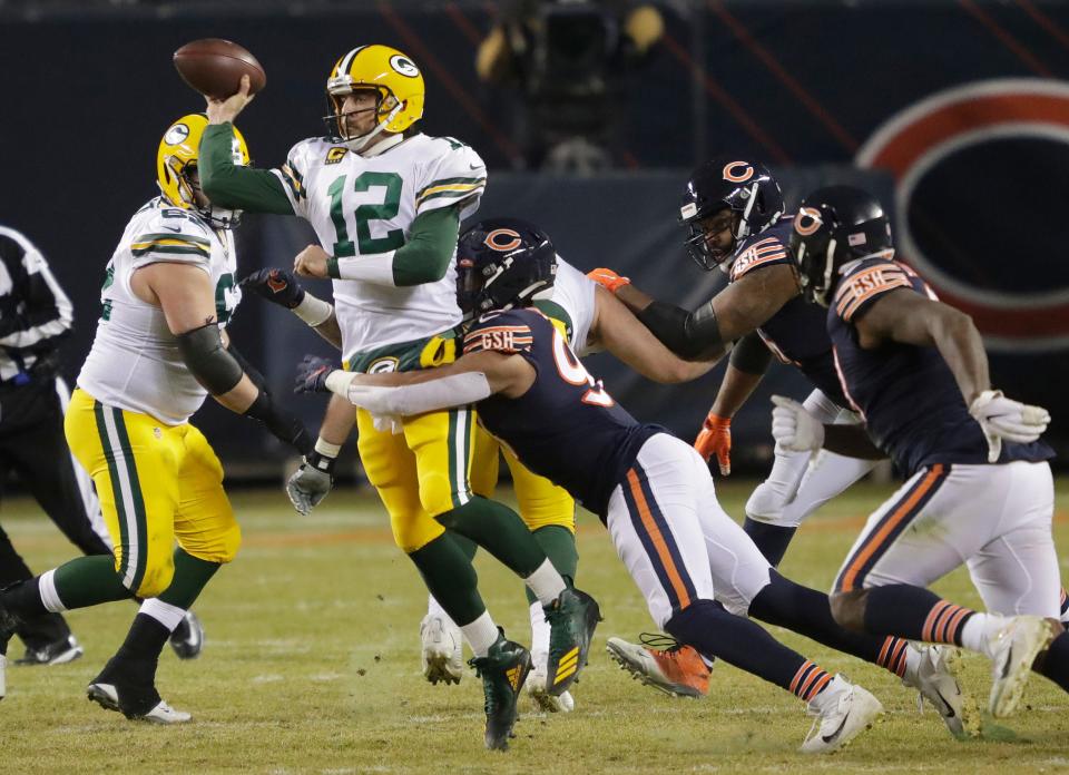 Green Bay Packers quarterback Aaron Rodgers (12) passes the ball under pressure from Chicago Bears linebacker Trevis Gipson (99) during their football game Sunday, January 3, 2021, at Soldier Field in Chicago, Ill. Dan Powers/USA TODAY NETWORK-Wisconsin
