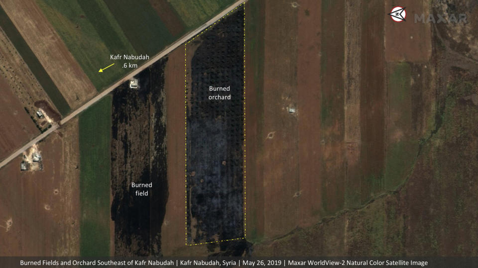 This satellite image provided by Maxar Technologies on Tuesday, May 28, 2019 shows significant damage to fields and orchards south of Kfar Nabudah, Syria, on May 26 as a result of a government offensive against the last rebel stronghold in the country. The images, provided to the Associated Press by the Colorado-based Maxar Technologies show fire still raging in olive groves and orchards during harvest season around Kfar Nabudah and Habeet, two villages on the edge of Idlib province where fighting has focused. (Maxar Technologies via AP)