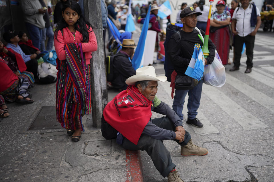 Indigenous people rest after accompanying President-elect Bernardo Arévalo in a march in protest of government interference in the elections he won in August, in Guatemala City, Thursday, Dec. 7, 2023. Arévalo is set to take office on Jan. 14, 2024. (AP Photo/Moises Castillo)