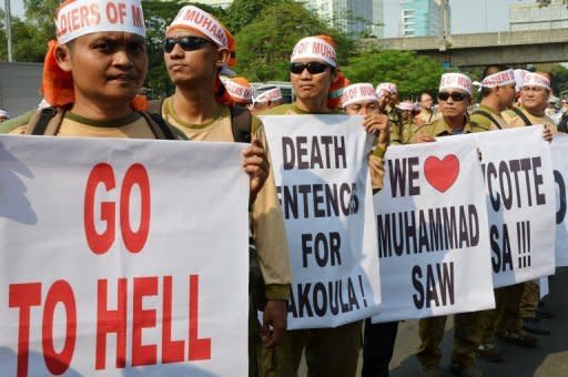 Indonesian members of the Justice and Prosperity Party hold banners during a protest against a low-budget American film insulting to Muslims outside the US embassy in Jakarta. As protests again erupted across the Muslim world on Wednesday over the film, a French magazine poured fuel on the fire by publishing obscene cartoons depicting the Prophet Mohammed