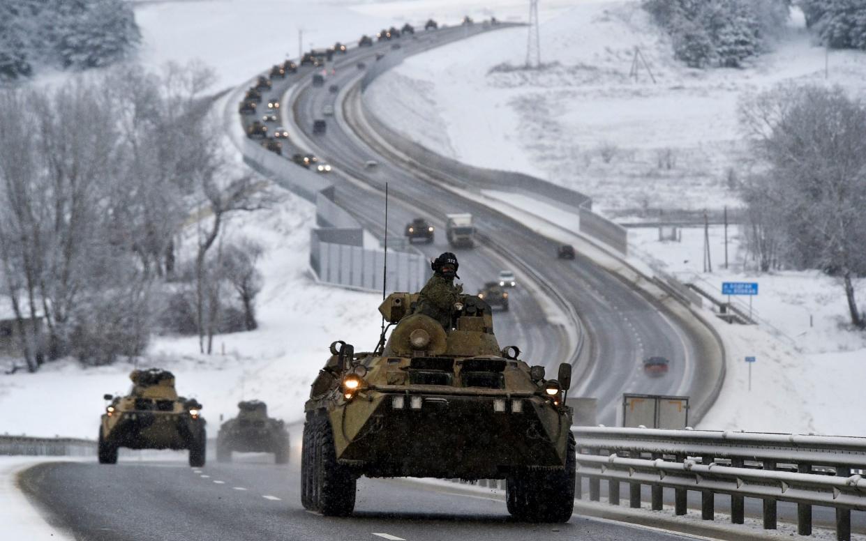 A convoy of Russian armored vehicles moves along a highway in Crimea - AP