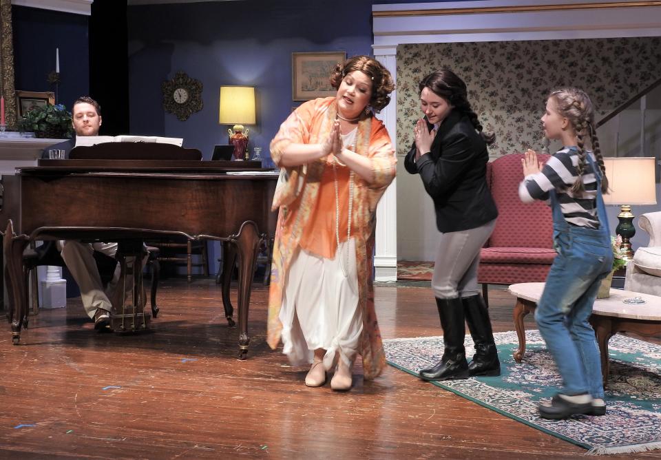 Heath Chaney as George Gould Strong plays the piano as Michelle Kittel as Big Edie, Sophia Dotson as Jackie Bouvier and Jozie Adams as Lee Bouvier sing and dance during a scene from "Grey Gardens" by the Coshocton Footlight Players.