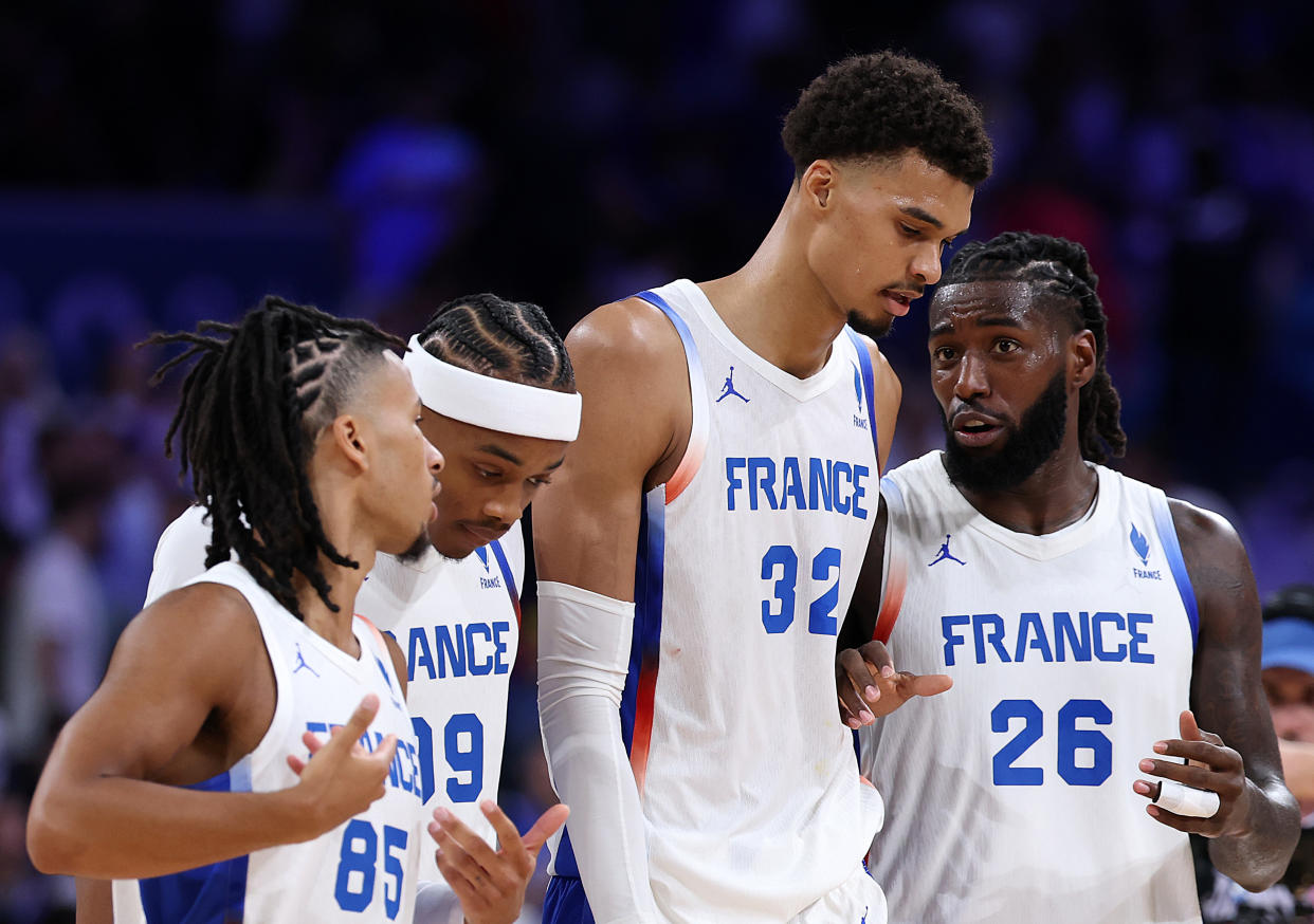 LILLE, FRANCE - JULY 27: Victor Wembanyama #32 of Team France talks to Mathias Lessort #26 of Team France during the Men's Group Phase - Group B game between France and Brazil on day one of the Olympic Games Paris 2024 at Stade Pierre Mauroy on July 27, 2024 in Lille, France. (Photo by Gregory Shamus/Getty Images)