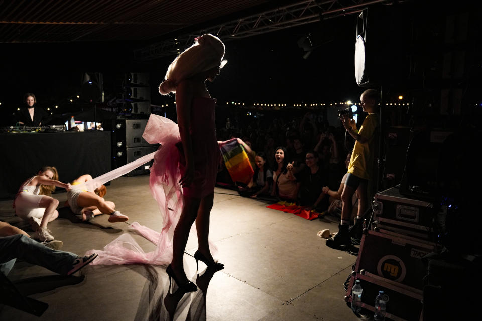 Ander Bishhe dances at Pride Park, a venue for artistic shows ahead the Pride 2021 in Bucharest, Romania, Thursday, Aug. 12, 2021. The 20th anniversary of the abolishment of Article 200, which authorized prison sentences of up to five years for same-sex relations, was one cause for celebration during the gay pride parade and festival held in Romania's capital this month. People danced, waved rainbow flags and watched performances at Bucharest Pride 2021, an event that would have been unimaginable a generation earlier. (AP Photo/Vadim Ghirda)