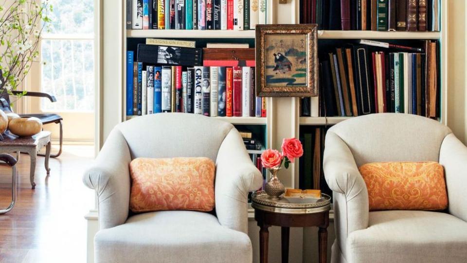 a room with a bookcase and a chair