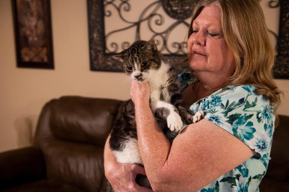 Mary Alston holds her cat Big Boy at her home in Wetumpka, Ala., on Thursday, Sept. 29, 2022.