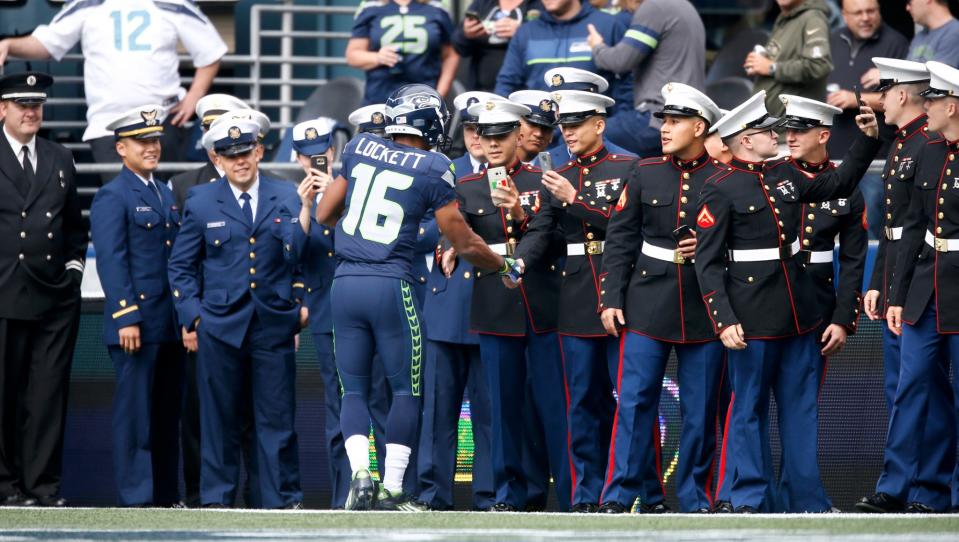<p>Wide receiver Tyler Lockett #16 of the Seattle Seahawks greets members of the U.S. Armed Services before the start of an NFL game against the Miami Dolphins at CenturyLink Field on September 11, 2016 in Seattle, Washington. (Photo by Otto Greule Jr/Getty Images) </p>