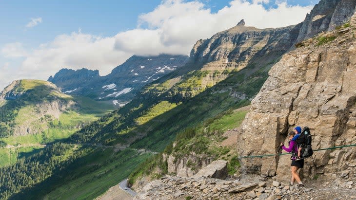 <span class="article__caption">A woman and little one hike the Highline Trail in Glacier. (Photo: Josh Miller Photography/Aurora-Photos/Getty) </span>