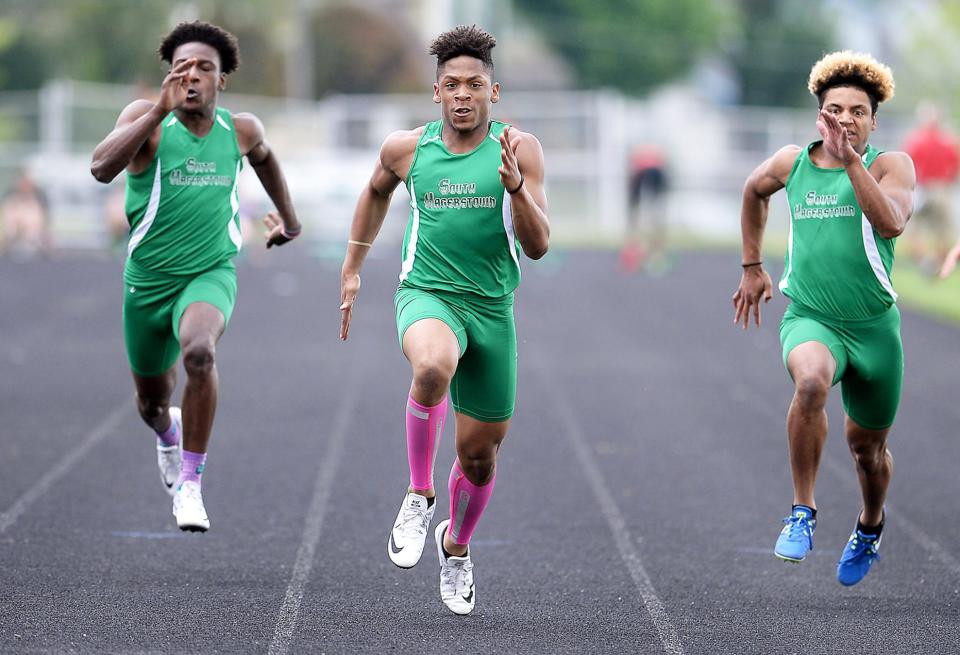 South Hagerstown’s Khalil Booker, center, wins the 100-meter dash during the 2018 Washington County Track and Field Championships.