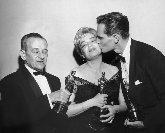 Left to right: American director William Wyler (1902 - 1981), French actress Simone Signoret (1921 - 1985) and American actor Charlton Heston with their trophies at the Academy Awards ceremony, held at the RKO Pantages Theatre, Los Angeles, California, 4th April 1960. Signoret won Best Actress for her role in &#39;Room at the Top&#39;, while Heston and Wyler won Best Actor and Best Director respectively for &#39;Ben Hur&#39;. (Photo by Phil Burchman/Hulton Archive/Getty Images)