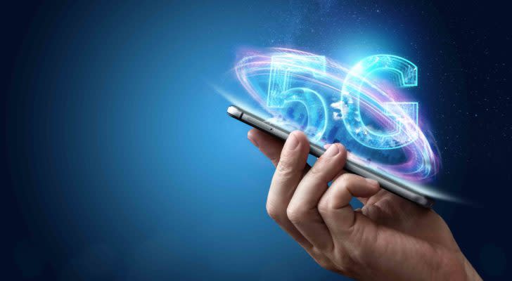 Hand holding phone with holographic "5G." represents 5g investing