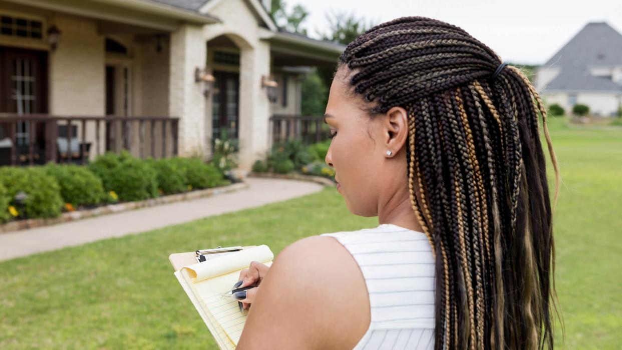 Before she puts the home on the market, the mid adult realtor evaluates the property.