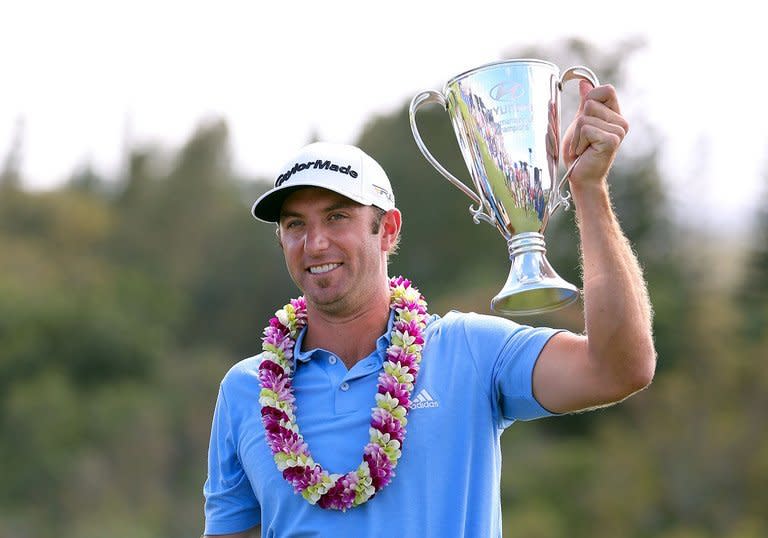 Dustin Johnson celebrates with the Hyundai Tournament of Champions Cup after firing a five-under 68 to win the weather-shortened event on January 8, 2013. "It gives me a lot of confidence going into this year," Johnson said of the win