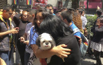 <p>Women embrace in the street after an earthquake in Mexico City, Tuesday, Sept. 19, 2017. A powerful earthquake has jolted Mexico, causing buildings to sway sickeningly in the capital on the anniversary of a 1985 quake that did major damage. (AP Photo/Eduardo Verdugo) </p>