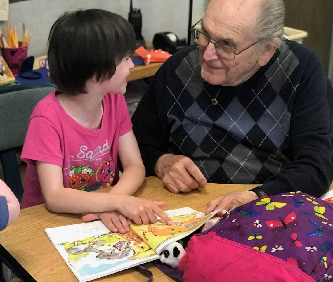 Long-time Communities in Schools of Peninsula mentor Hugh McMillan reads with a mentee at Evergreen Elementary.
