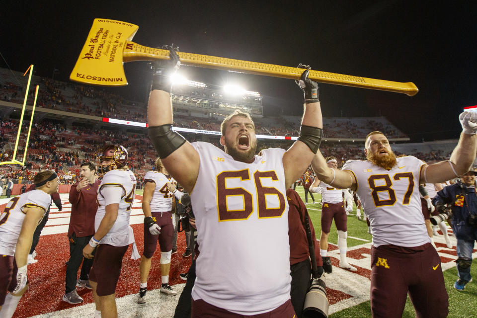 Nov. 26, 2022; Madison, Wisconsin; The Minnesota Golden Gophers celebrate with the Paul Bunyan Axe following the game against the Wisconsin Badgers at Camp Randall Stadium. Jeff Hanisch-USA TODAY Sports