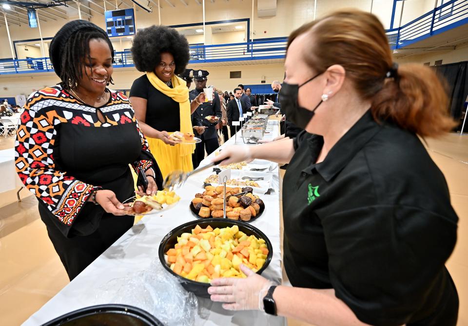 Chantel (no last name provided), left, and Suzanne Graham-Anderson, both of Worcester, make their way through the buffet line during the 39th Annual Martin Luther King Jr. Community Breakfast Monday at Assumption University honoring Martin Luther King Jr..