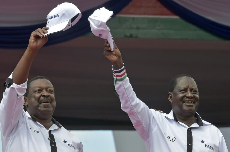 Former prime minister Raila Odinga (right) and ex-deputy premier Wycliffe Musalia Mudavadi greet supporters during an opposition rally in Nairobi, on April 27, 2017