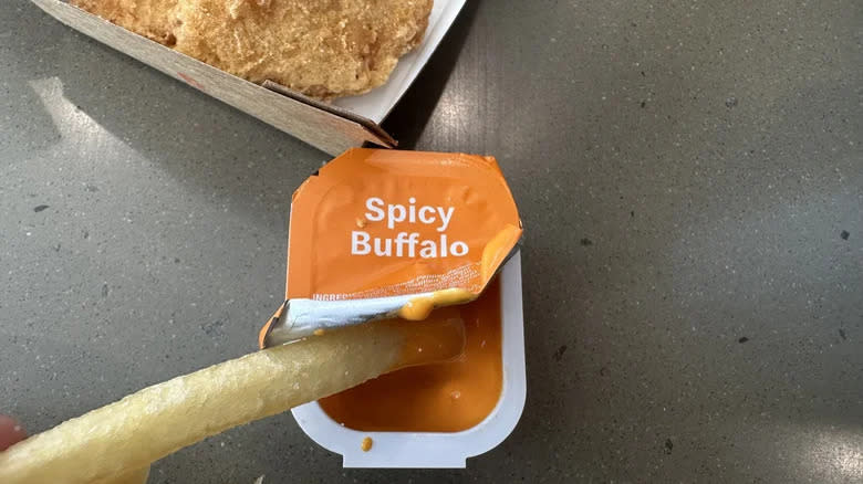 fry dipped in buffalo sauce