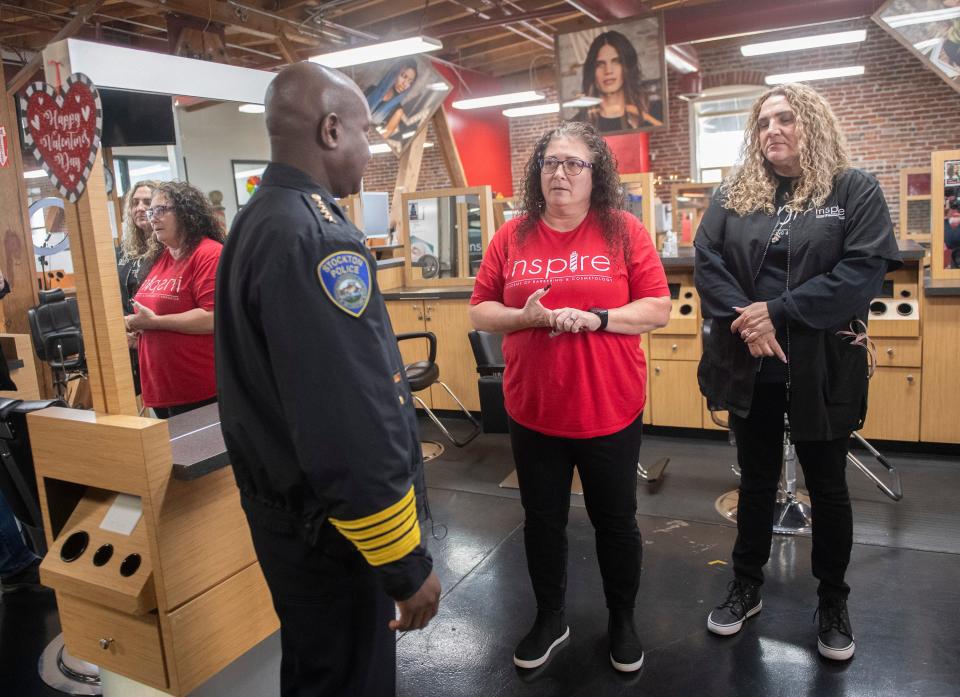 Stockton Police Chief Stanley McFadden, left, talks with directors at the Inspire Academy of Barbering and Cosmetology Michelle Hickman, center, and Kim Ornelas at the Waterfront Warehouse in downtown Stockton during a police community walkthrough on Tuesday, Feb. 7, 2023 after a multiple shooting that left one person dead and two others wounded at the business complex on Saturday night.